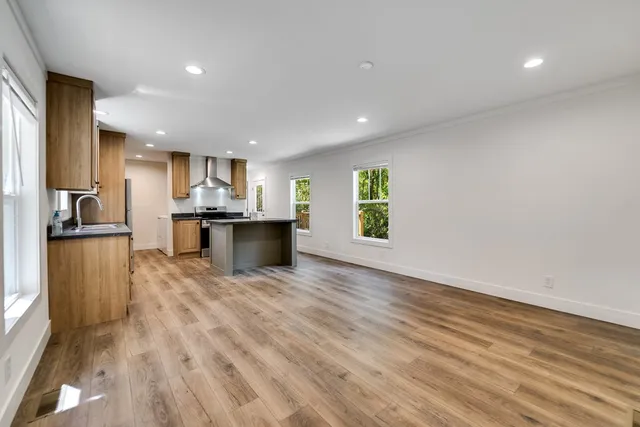 a view of kitchen with kitchen island microwave and refrigerator