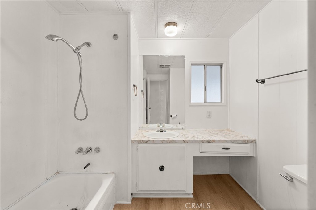 1255 Amethyst Street, Unit 32 Mentone, CA 92359 - Photo 17 of 32 a bathroom with a sink vanity granite tub and shower