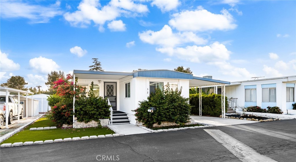 1255 Amethyst Street, Unit 32 Mentone, CA 92359 - Photo 2 of 32 a front view of a house with garden