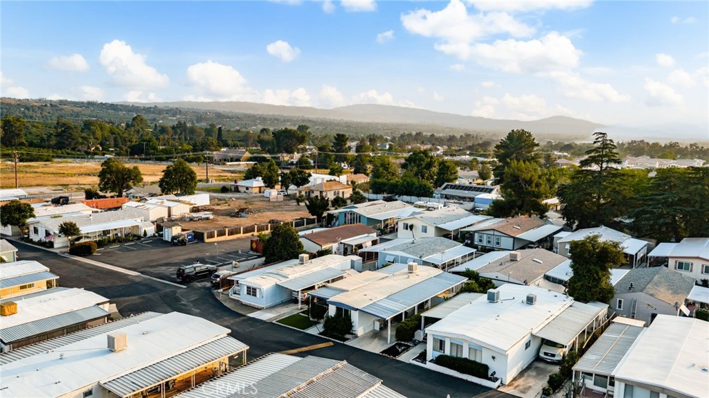 1255 Amethyst Street, Unit 32 Mentone, CA 92359 - Photo 23 of 32 an aerial view of a city with lots of residential buildings and ocean view in back
