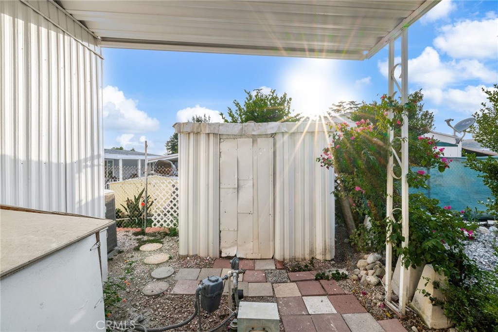 1255 Amethyst Street, Unit 32 Mentone, CA 92359 - Photo 29 of 32 a potted plant sitting in front of a house
