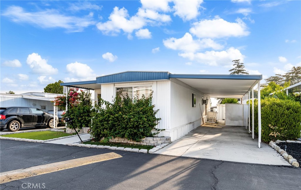 1255 Amethyst Street, Unit 32 Mentone, CA 92359 - Photo 3 of 32 a front view of a house with garden