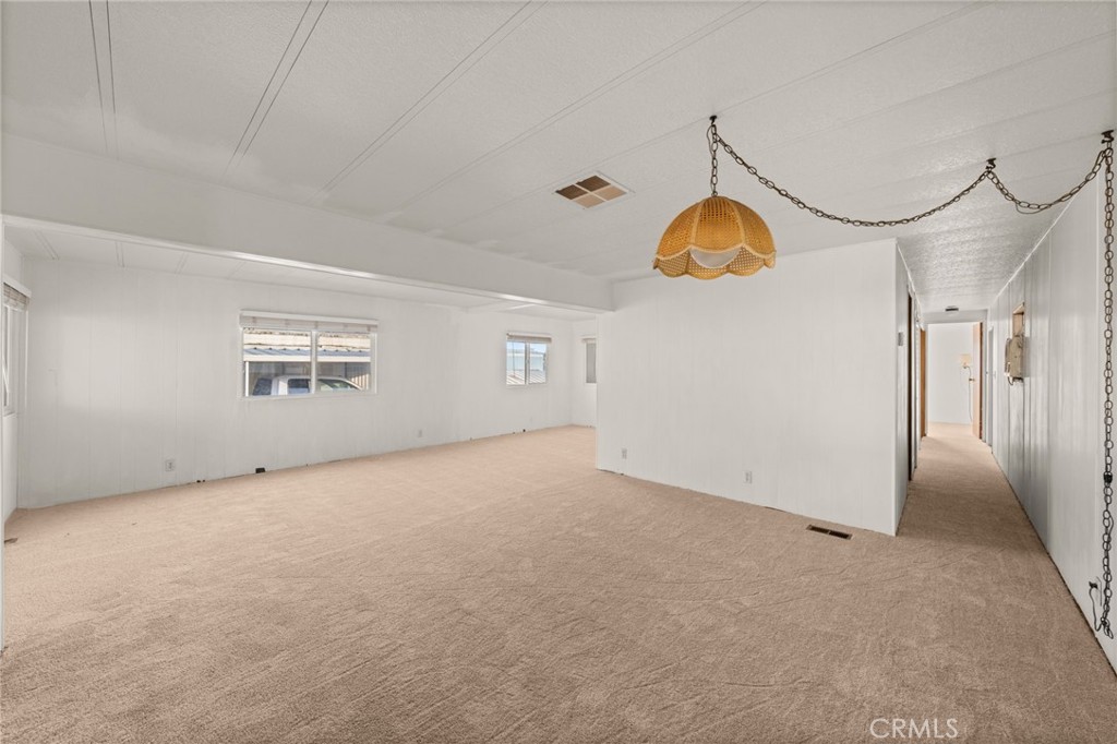 1255 Amethyst Street, Unit 32 Mentone, CA 92359 - Photo 8 of 32 an empty room with windows and fan