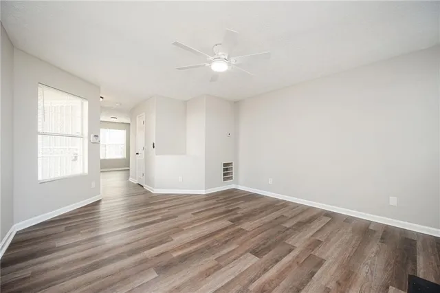wooden floor in an empty room with a window