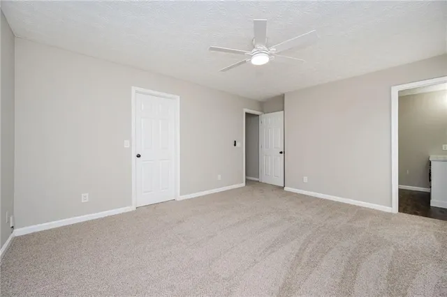 a view of an empty room with a ceiling fan