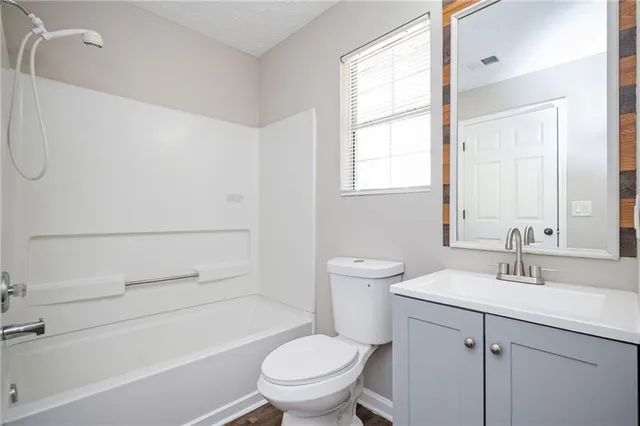 a bathroom with a sink a toilet and a bathtub
