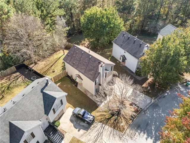 an aerial view of a house with a yard