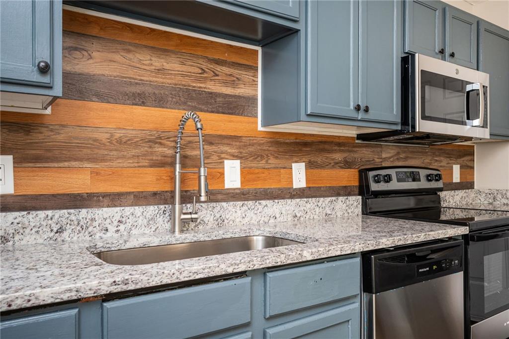 3375 River Run Trail Decatur, GA 30034 - Photo 8 of 27 a kitchen with granite countertop a sink and a stove