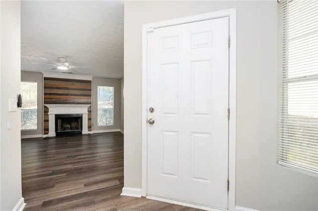 a view of a livingroom with wooden floor and a fireplace