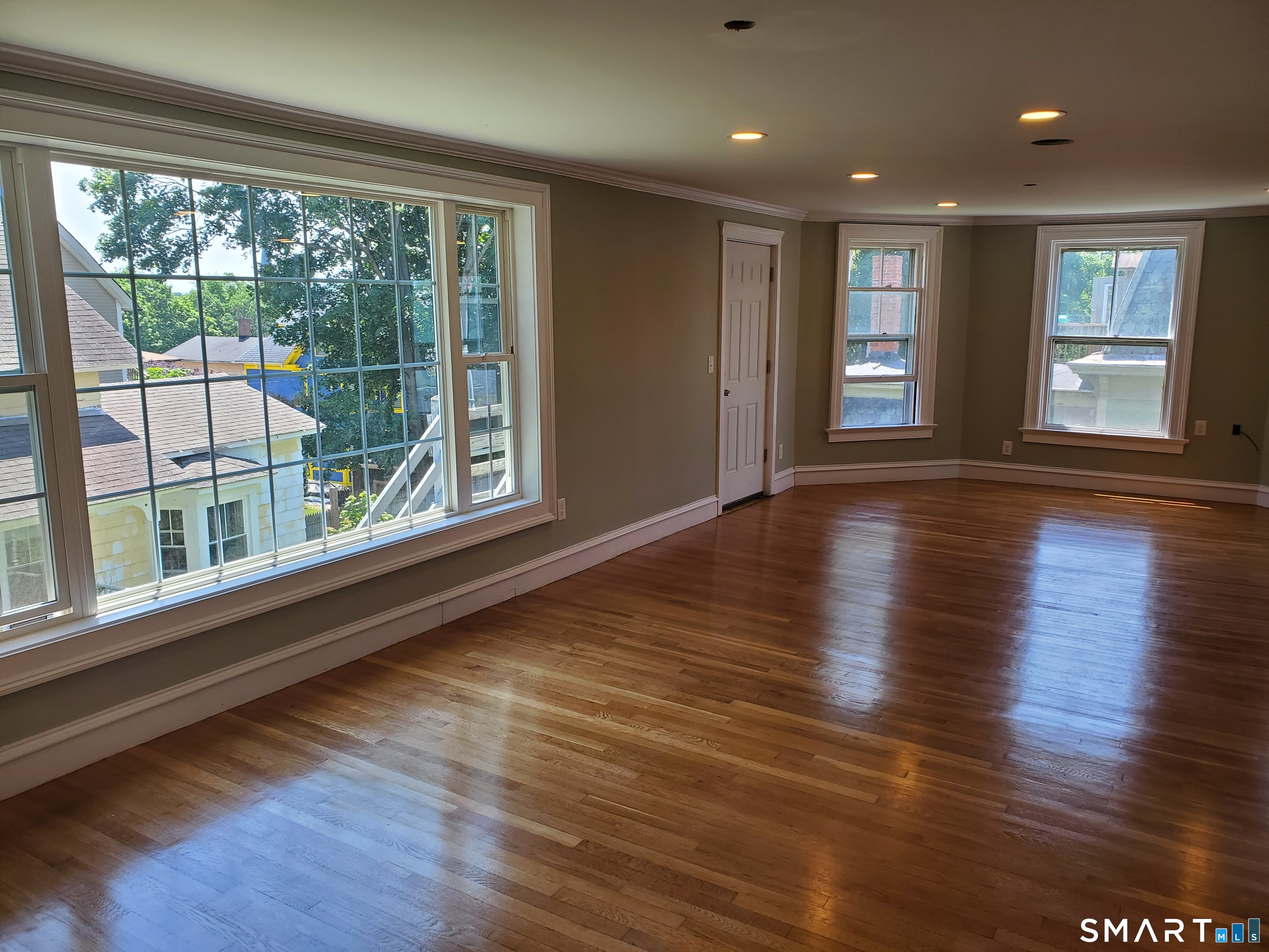 31 Bellevue Street Windham, CT 06226 - Photo 12 of 16 a view of an empty room with wooden floor and a window