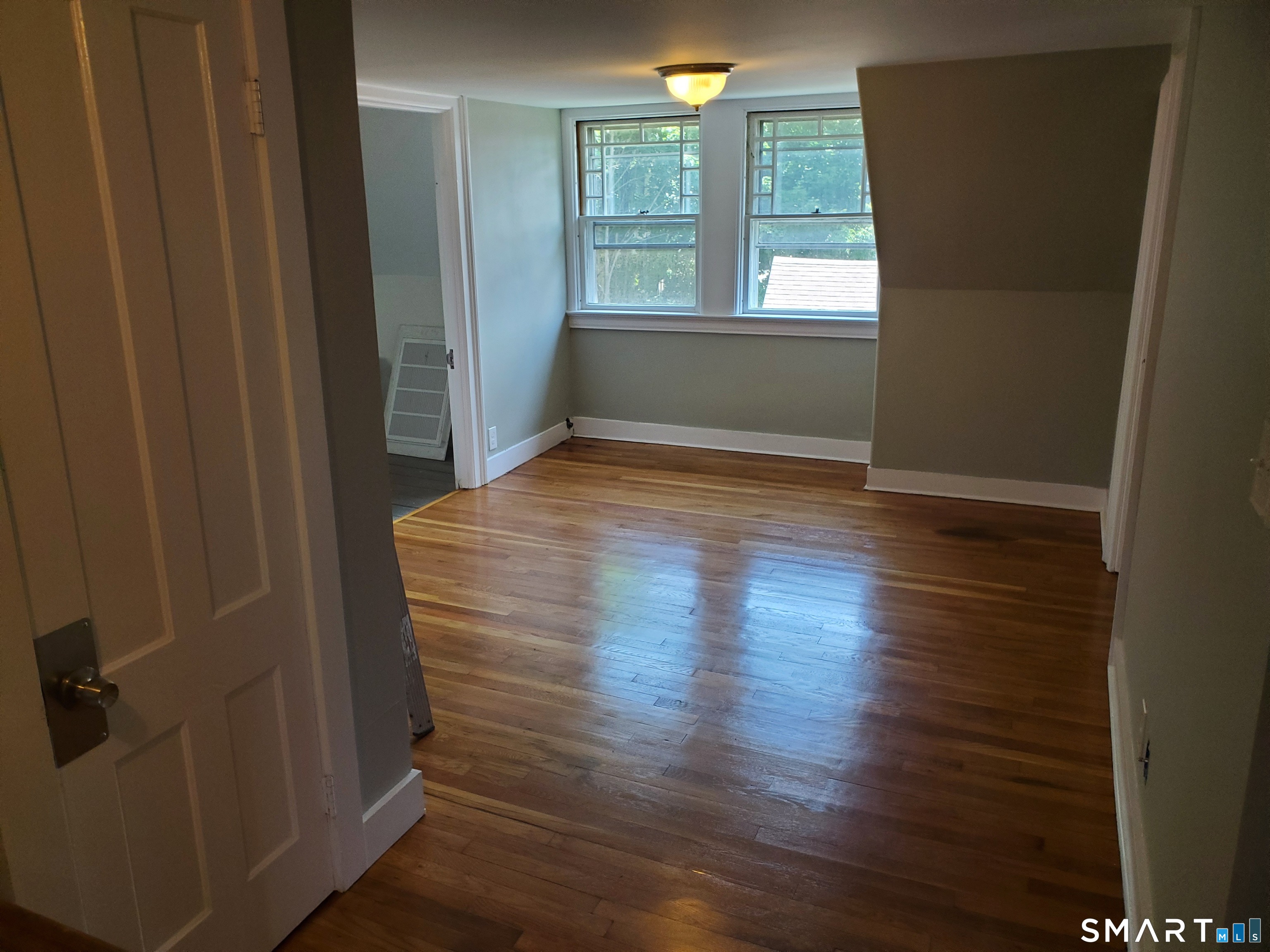 31 Bellevue Street Windham, CT 06226 - Photo 3 of 16 a view of wooden floor and windows in a room