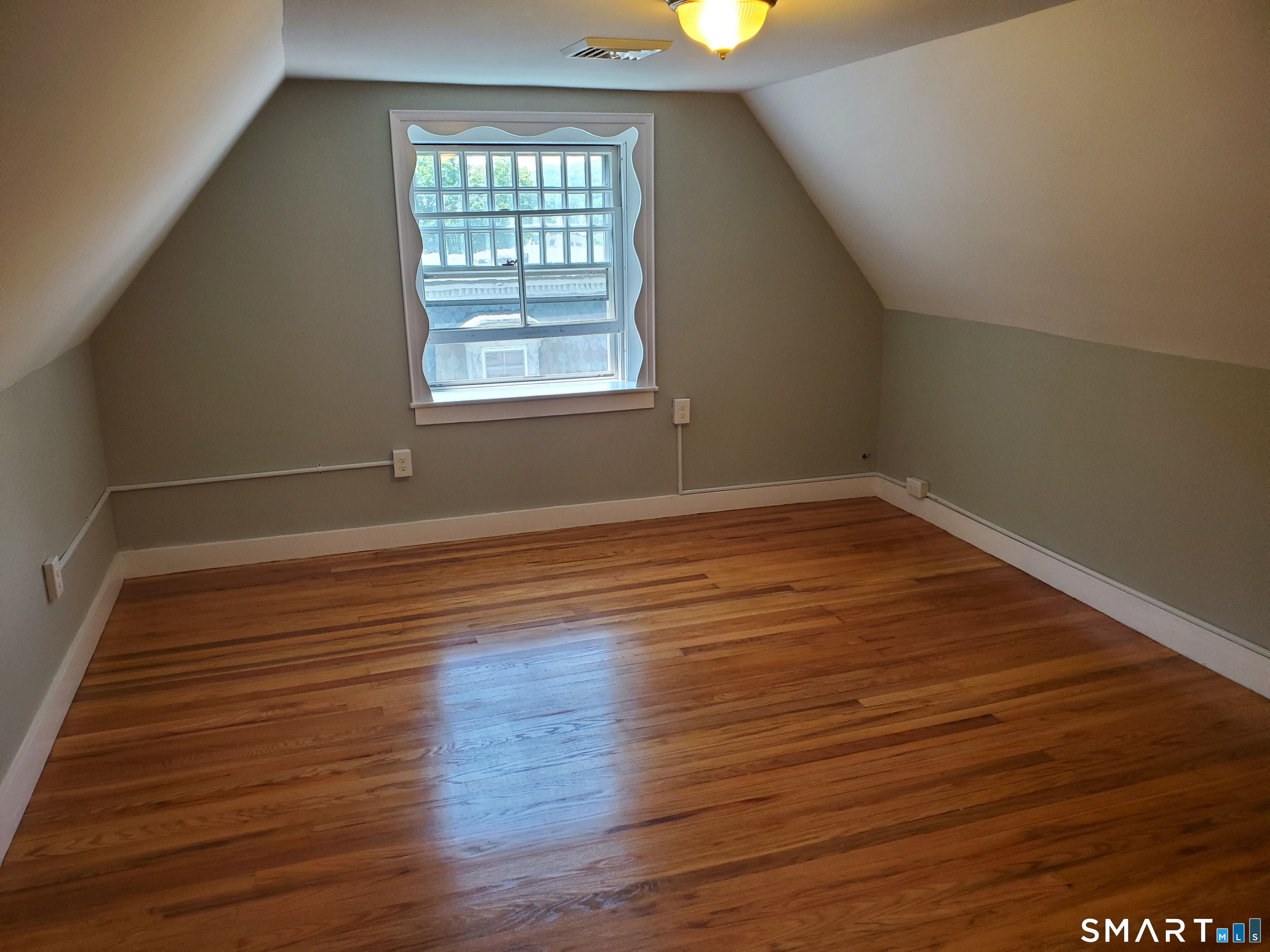 31 Bellevue Street Windham, CT 06226 - Photo 4 of 16 wooden floor in an empty room with a window