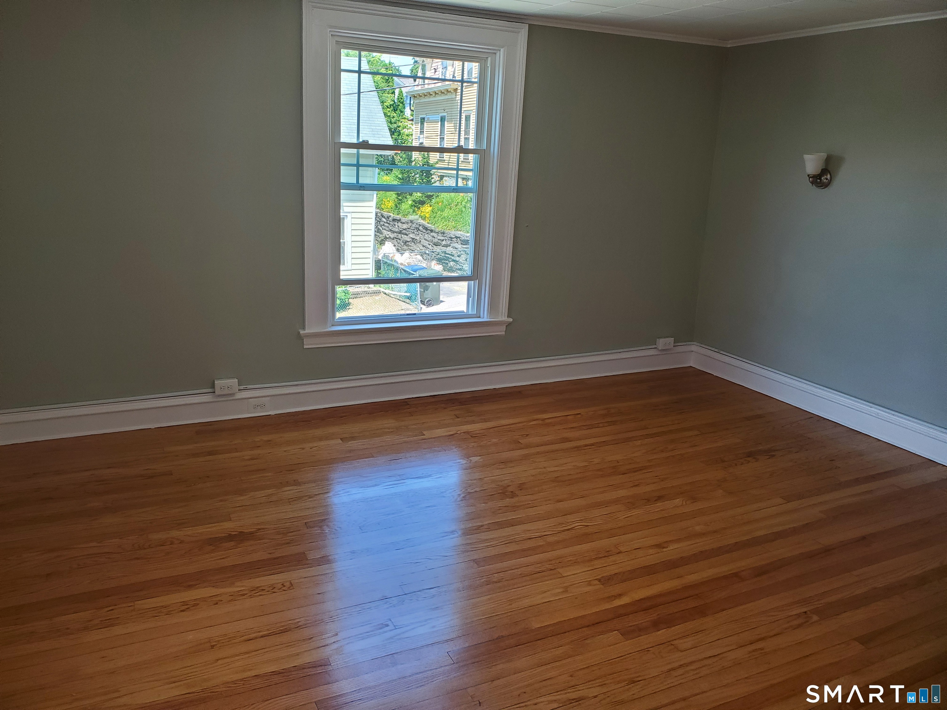 31 Bellevue Street Windham, CT 06226 - Photo 9 of 16 an empty room with wooden floor and windows