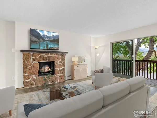 a view of empty room with wooden floor and fireplace