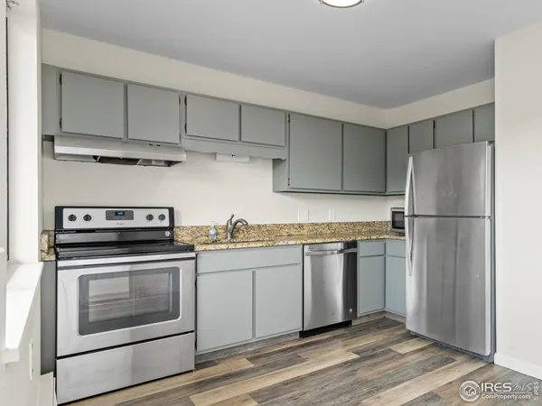 a kitchen with stainless steel appliances granite countertop a sink and a stove