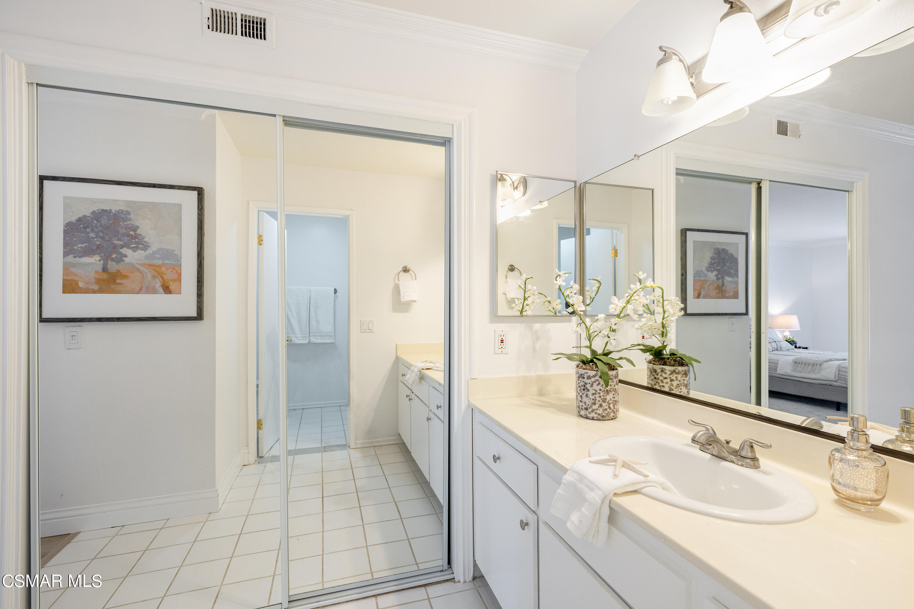 1736 Sinaloa Road, Unit 313 Simi Valley, CA 93065 - Photo 11 of 27 a spacious bathroom with a double vanity sink mirror and double