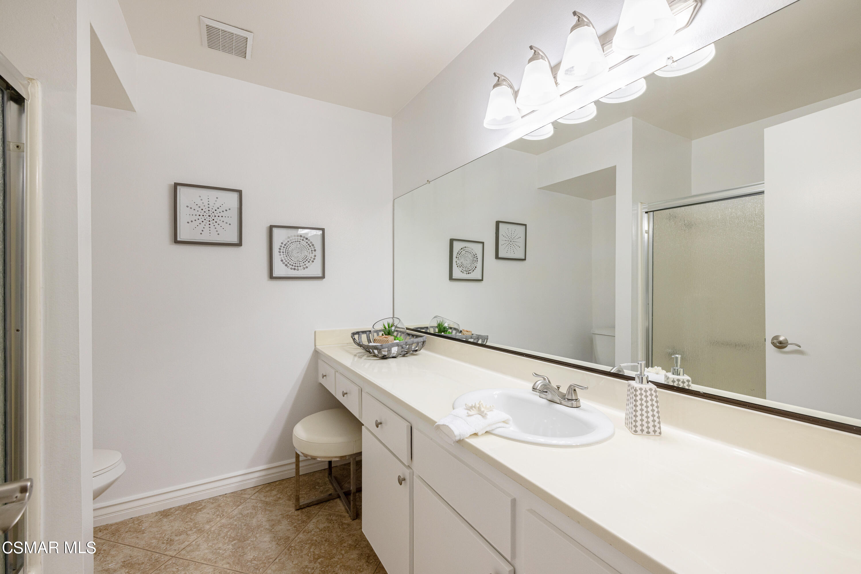 1736 Sinaloa Road, Unit 313 Simi Valley, CA 93065 - Photo 15 of 27 a bathroom with a sink vanity and a mirror