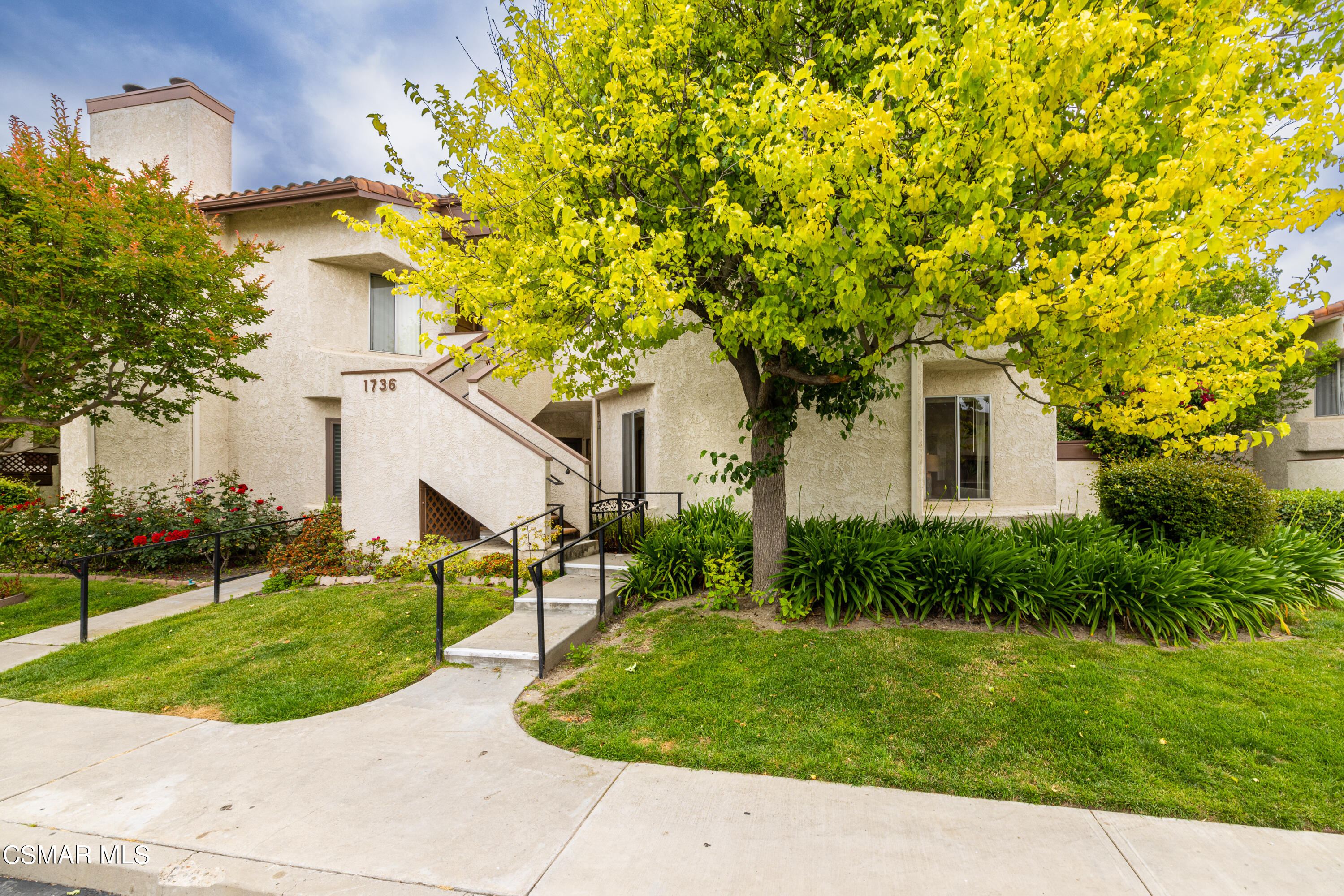 1736 Sinaloa Road, Unit 313 Simi Valley, CA 93065 - Photo 2 of 27 a front view of a house with garden
