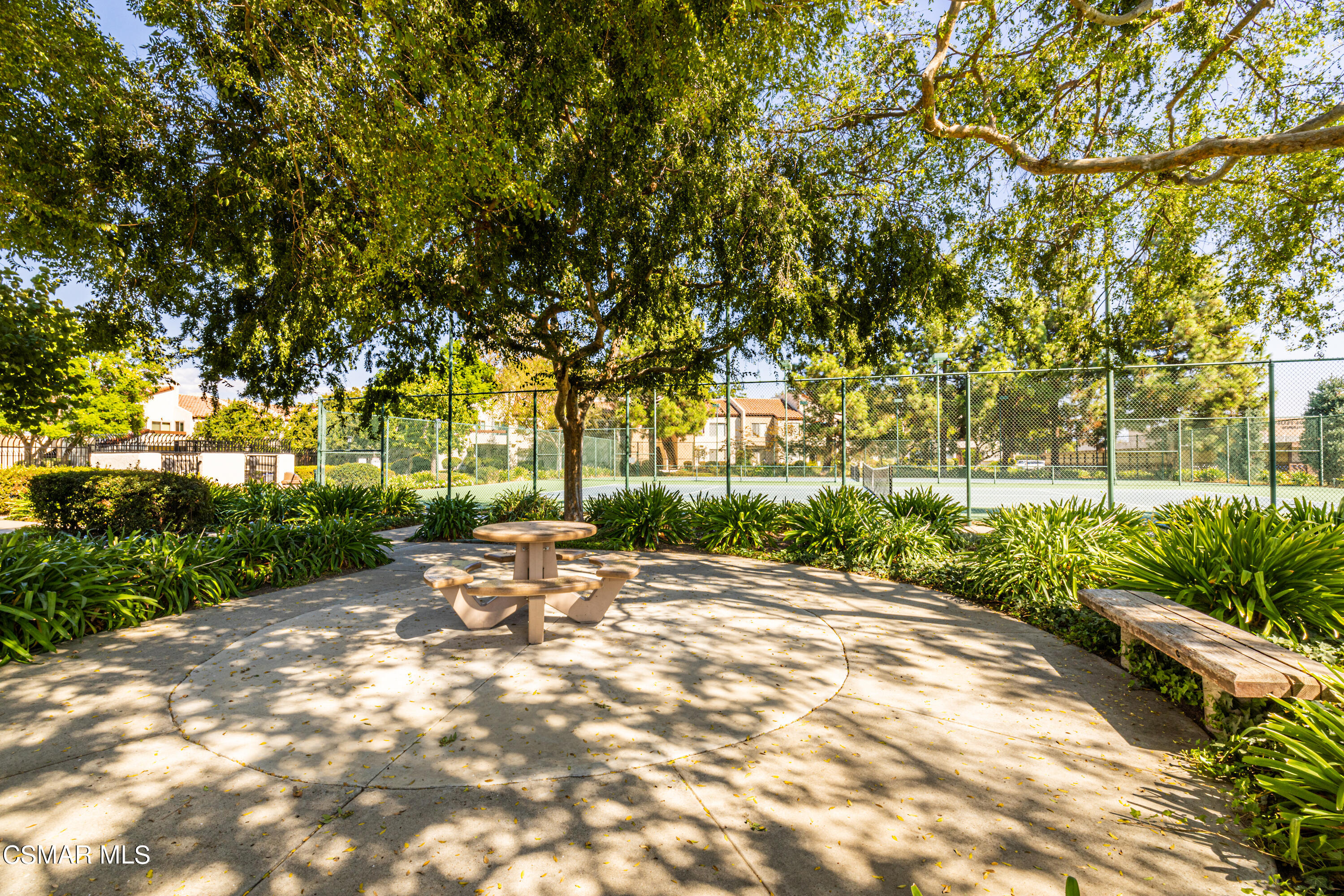 1736 Sinaloa Road, Unit 313 Simi Valley, CA 93065 - Photo 24 of 27 a view of a patio with table and chairs under an umbrella