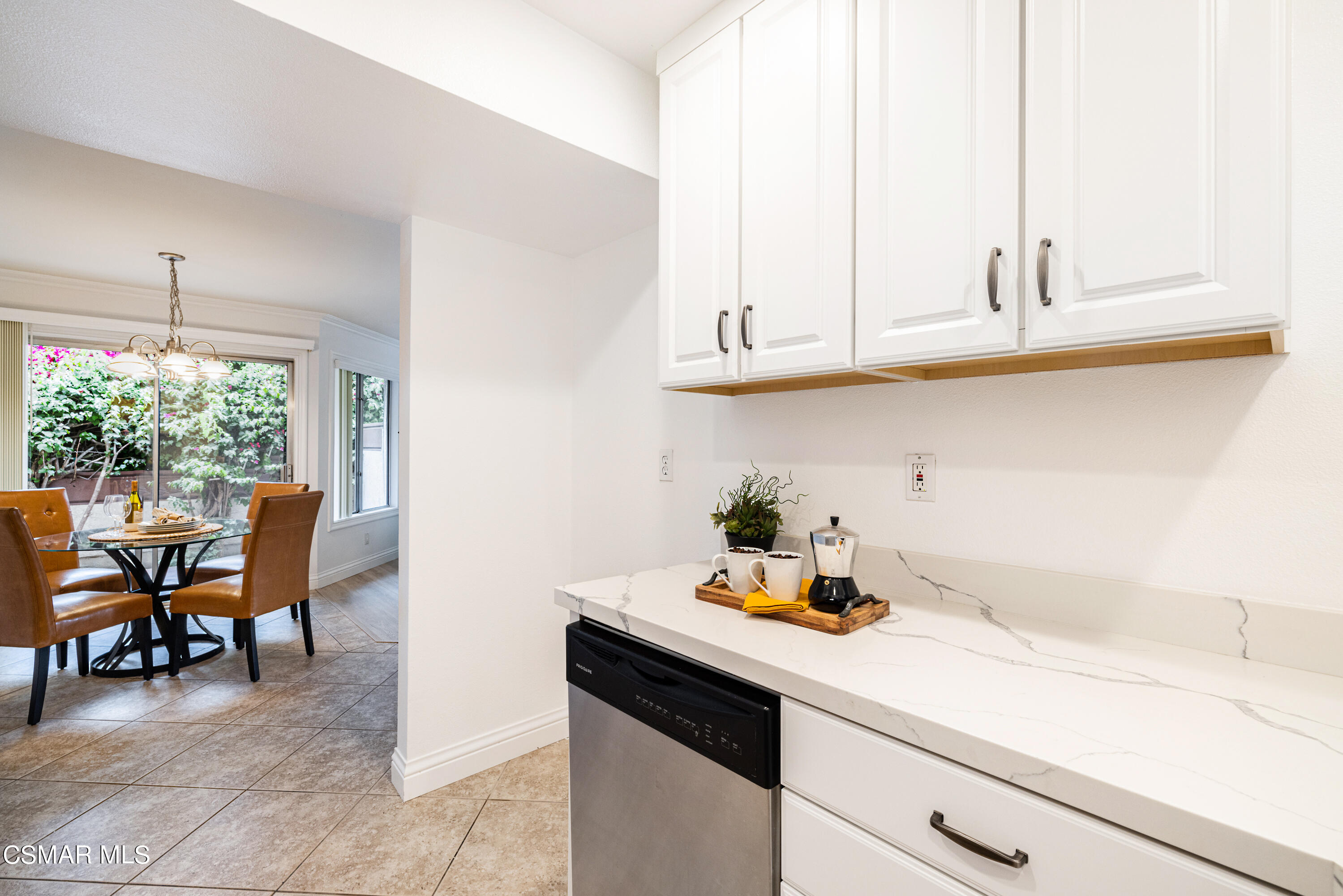 1736 Sinaloa Road, Unit 313 Simi Valley, CA 93065 - Photo 7 of 27 a kitchen with appliances cabinets and chair