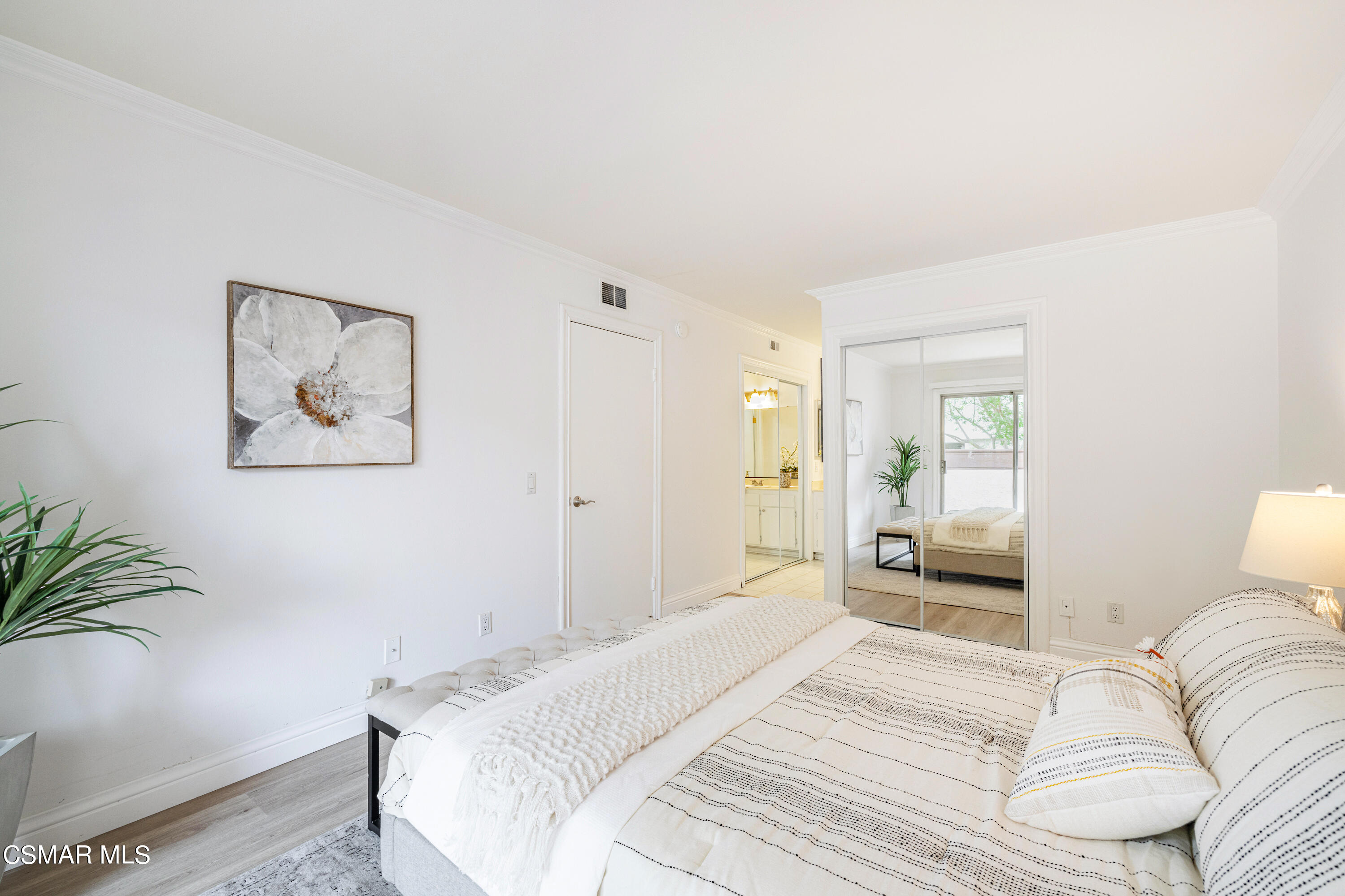 1736 Sinaloa Road, Unit 313 Simi Valley, CA 93065 - Photo 10 of 27 a bedroom with a bed and a potted plant