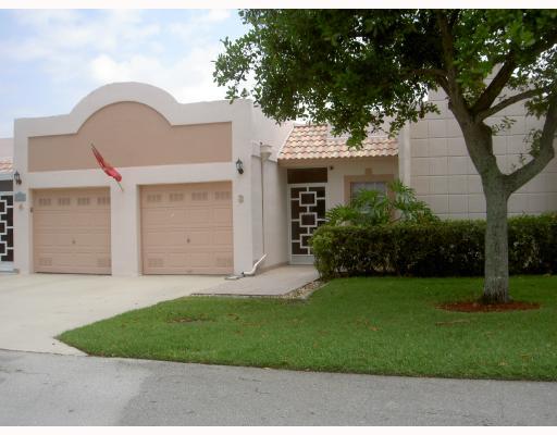18999 Stewart Circle, Unit 3 Boca Raton, FL 33496 - Photo 1 of 14 a front view of a house with a garden and yard