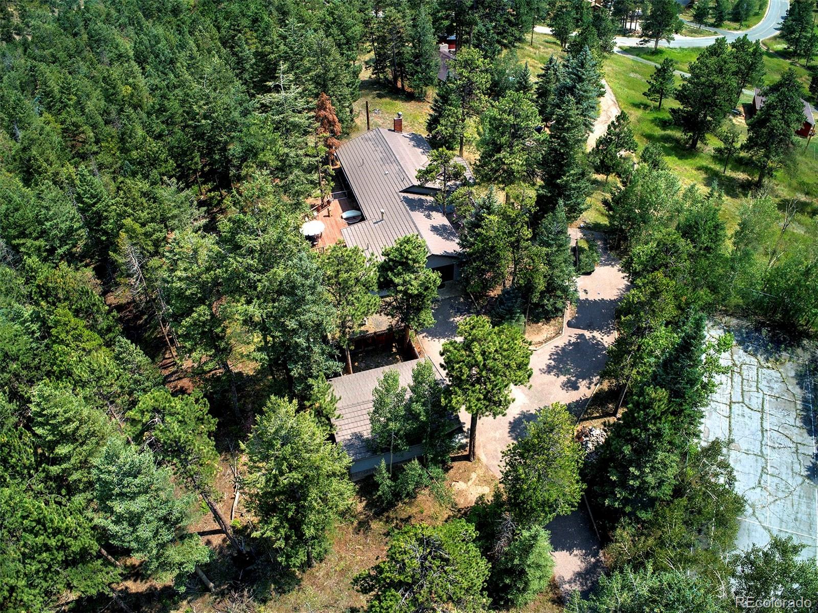 11655 Ranch Elsie Road Golden, CO 80403 - Photo 11 of 36 an aerial view of a house with a yard and lake view