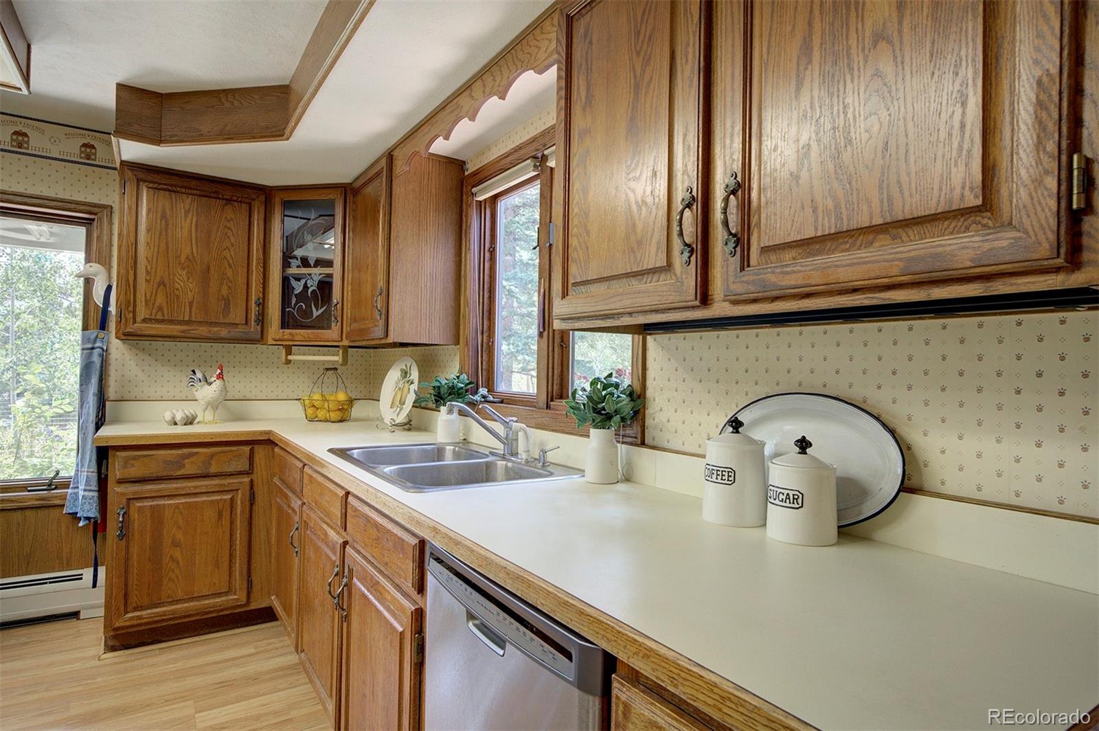 11655 Ranch Elsie Road Golden, CO 80403 - Photo 16 of 36 a kitchen with a sink cabinets and stainless steel appliances