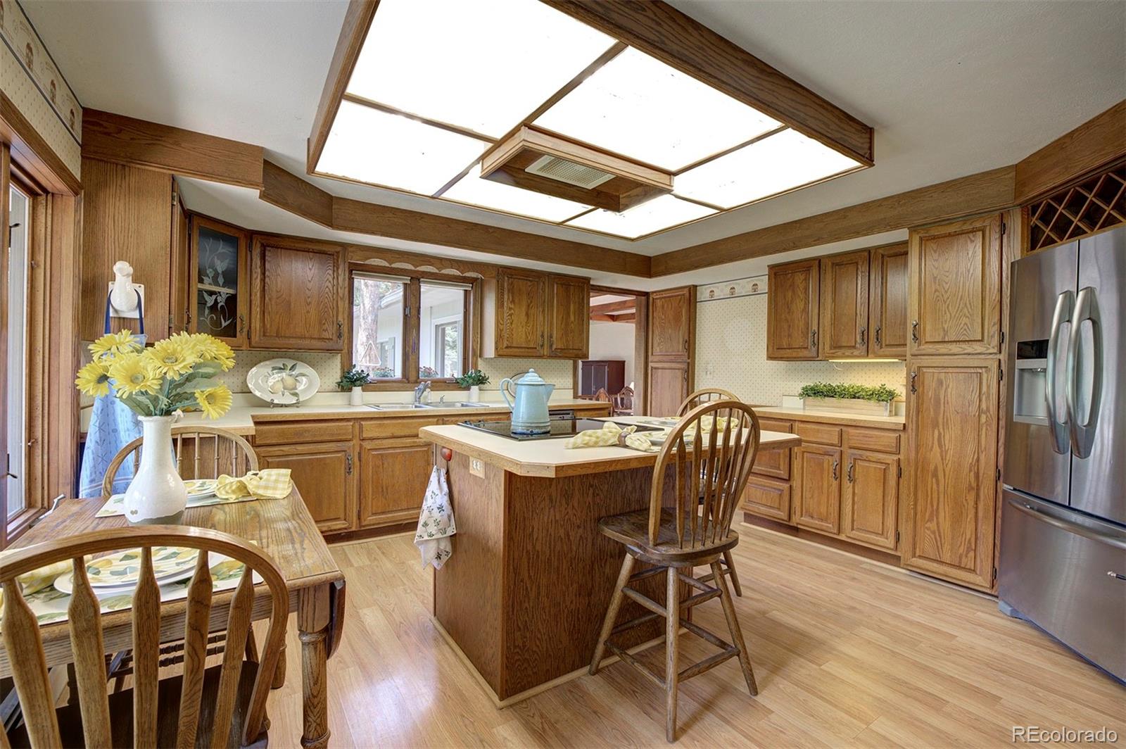 11655 Ranch Elsie Road Golden, CO 80403 - Photo 20 of 36 a dining room with furniture a window and wooden floor
