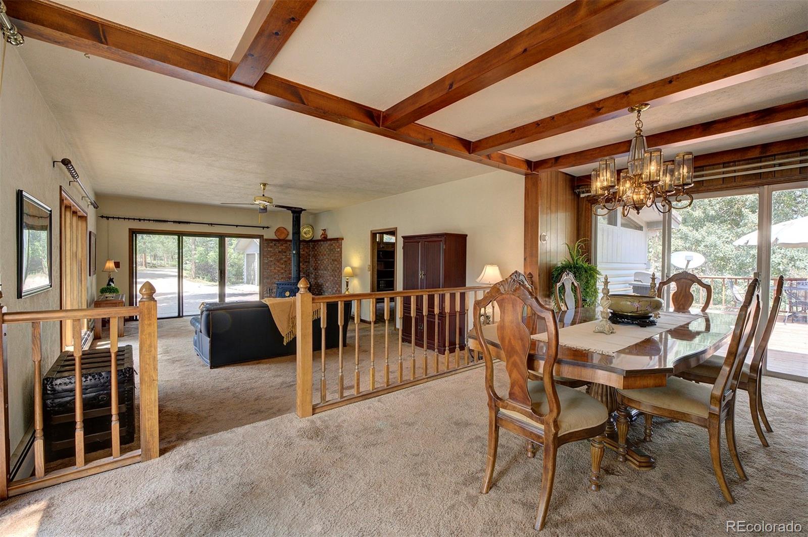 11655 Ranch Elsie Road Golden, CO 80403 - Photo 24 of 36 a view of a dining room with furniture wooden floor and chandelier