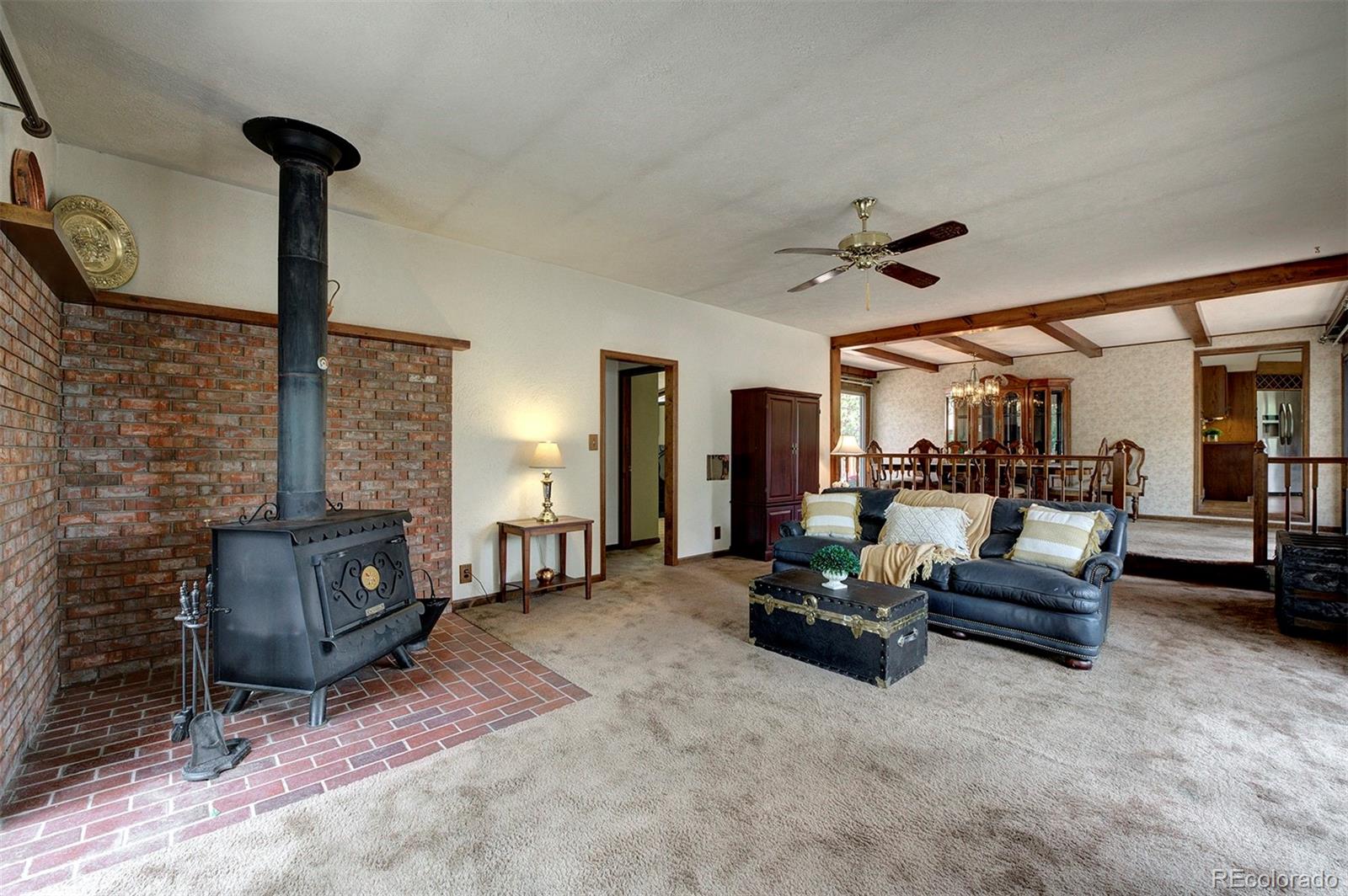 11655 Ranch Elsie Road Golden, CO 80403 - Photo 26 of 36 a living room with furniture and a fireplace