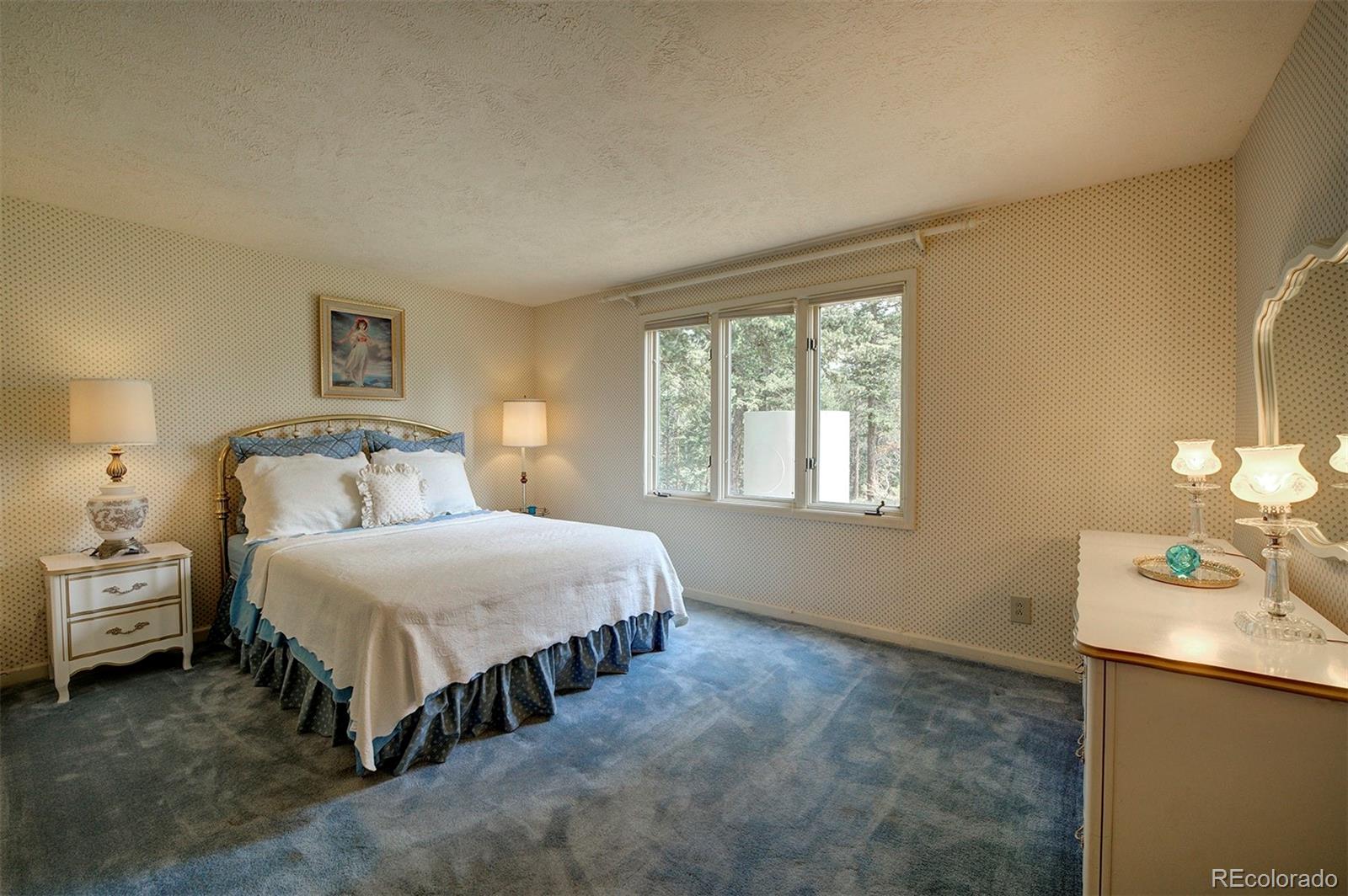 11655 Ranch Elsie Road Golden, CO 80403 - Photo 31 of 36 a bedroom with a bed and a table