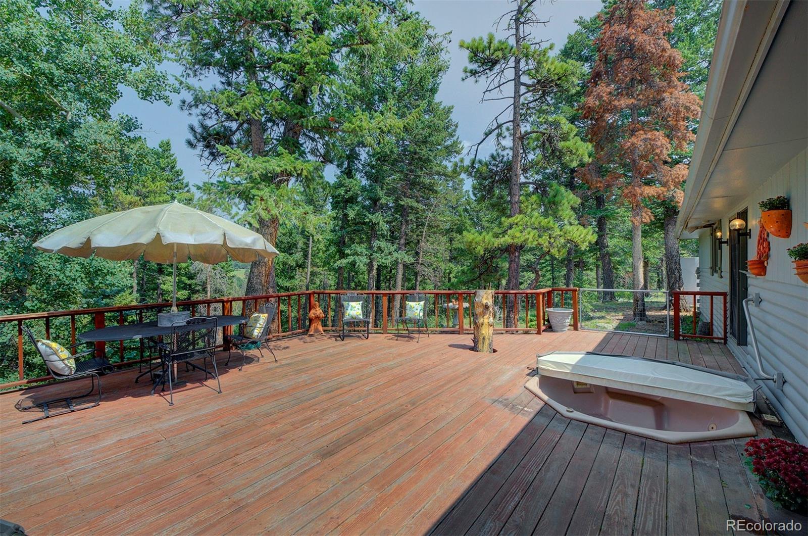 11655 Ranch Elsie Road Golden, CO 80403 - Photo 34 of 36 a view of a chairs and table on the wooden roof deck
