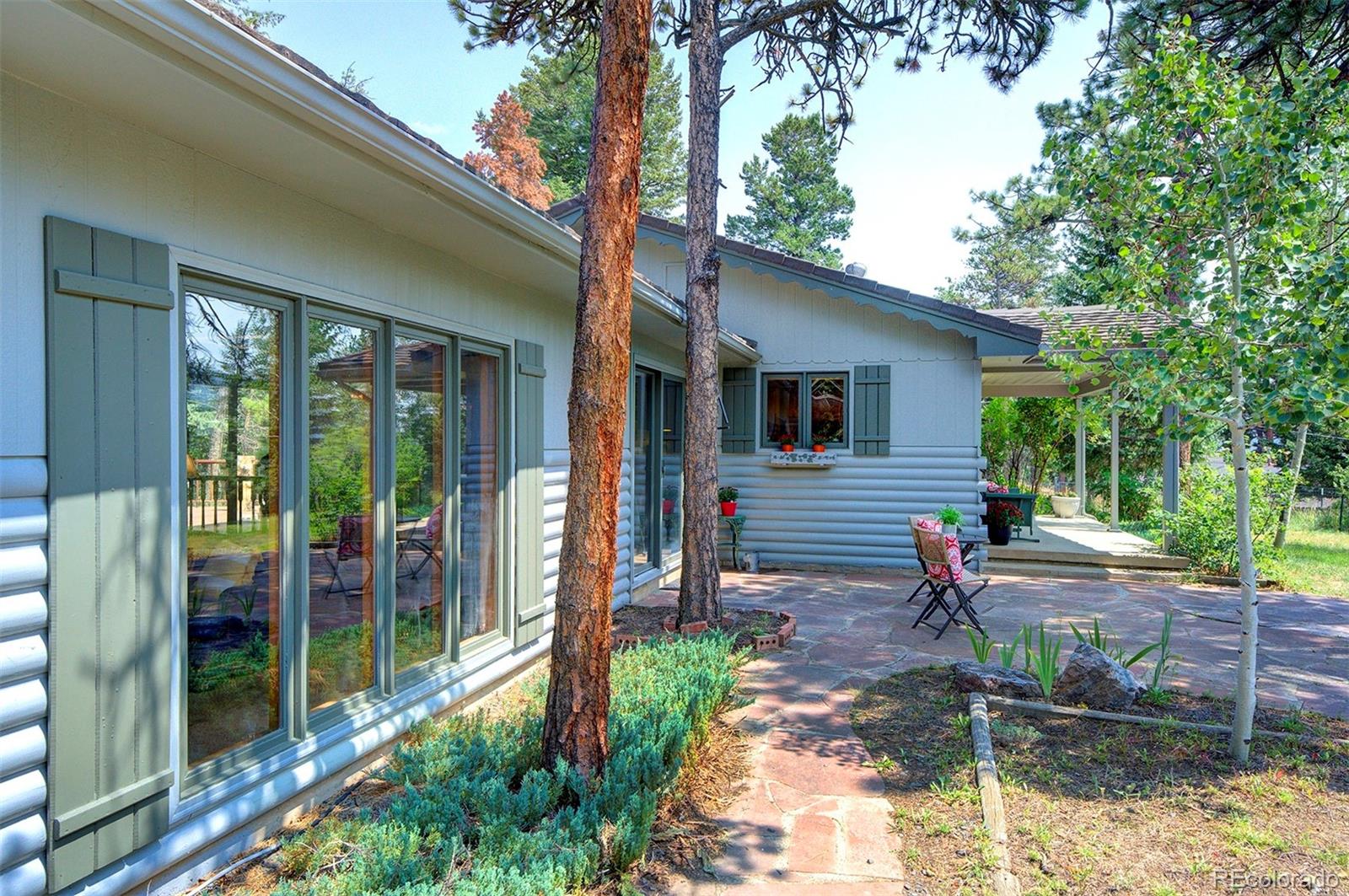 11655 Ranch Elsie Road Golden, CO 80403 - Photo 5 of 36 a view of a house with backyard and a tree