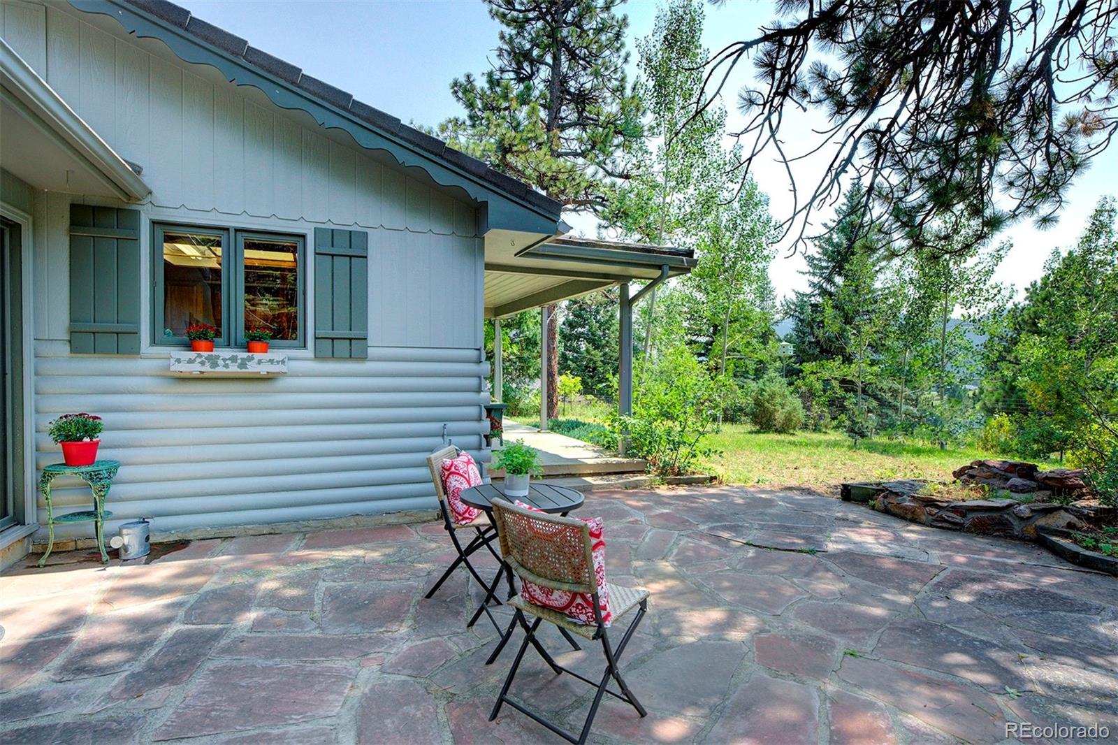 11655 Ranch Elsie Road Golden, CO 80403 - Photo 7 of 36 a view of backyard with seating space and trees in the background