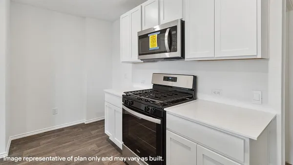 a kitchen with stainless steel appliances granite countertop a stove and a microwave