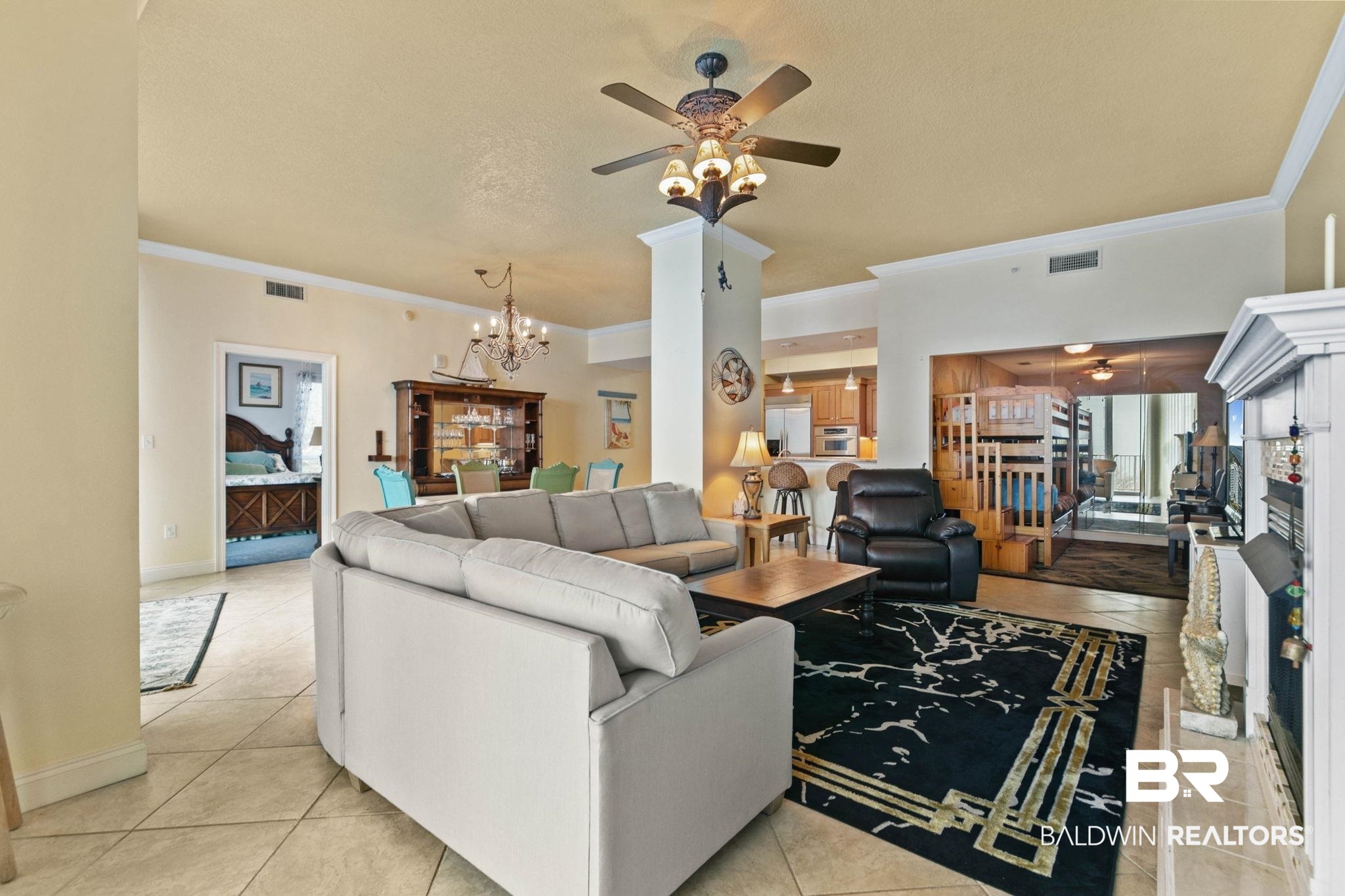 28250 Canal Road, Unit 208 Orange Beach, AL 36561 - Photo 11 of 53 Living area featuring ceiling fan, ornamental molding, suspended lighting, and light tile patterned flooring