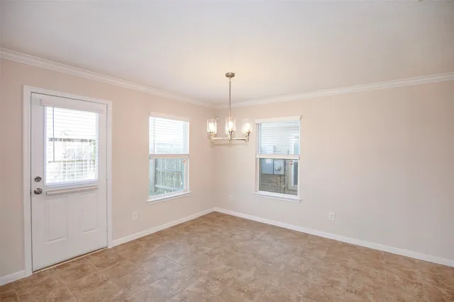 an empty room with windows and cabinet