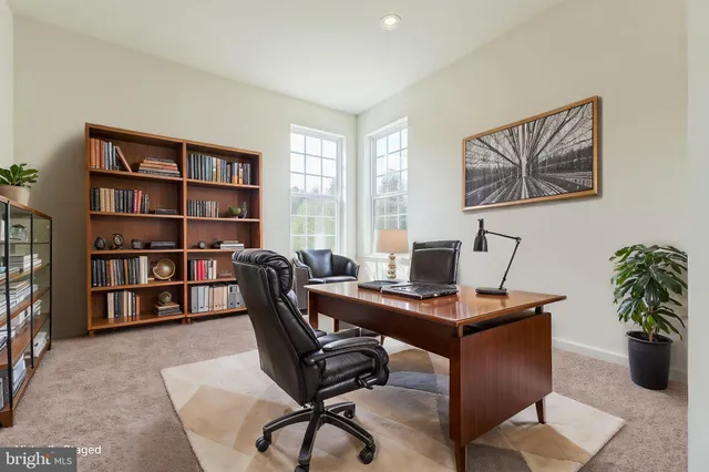 a view of a workspace with a bookshelf