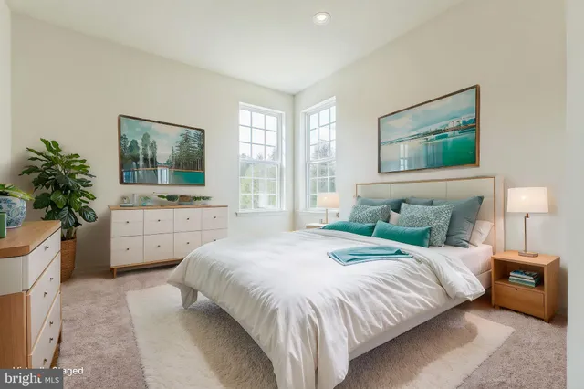 a bedroom with a large bed and a flat screen tv