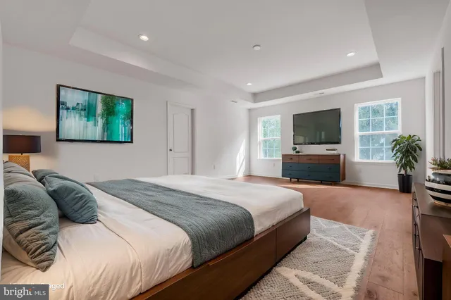 a bedroom with a large bed and a flat screen tv