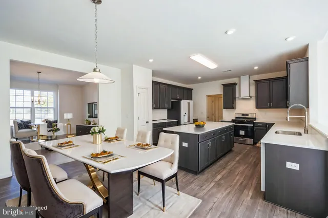 a large kitchen with a table and chairs