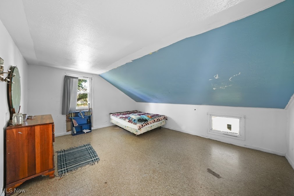 15298 Shedd Road Middlefield, OH 44062 - Photo 9 of 30 Bedroom featuring vaulted ceiling and a textured ceiling