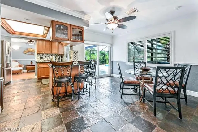 a dining room with furniture a large window and a rug