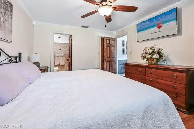 a bedroom with a bed and a dresser