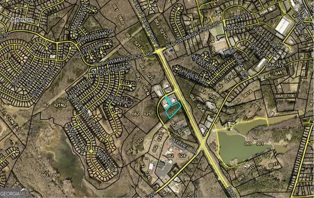 an aerial view of residential houses with outdoor space and trees