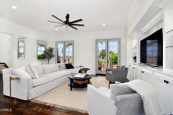 a living room with furniture fireplace and a large window