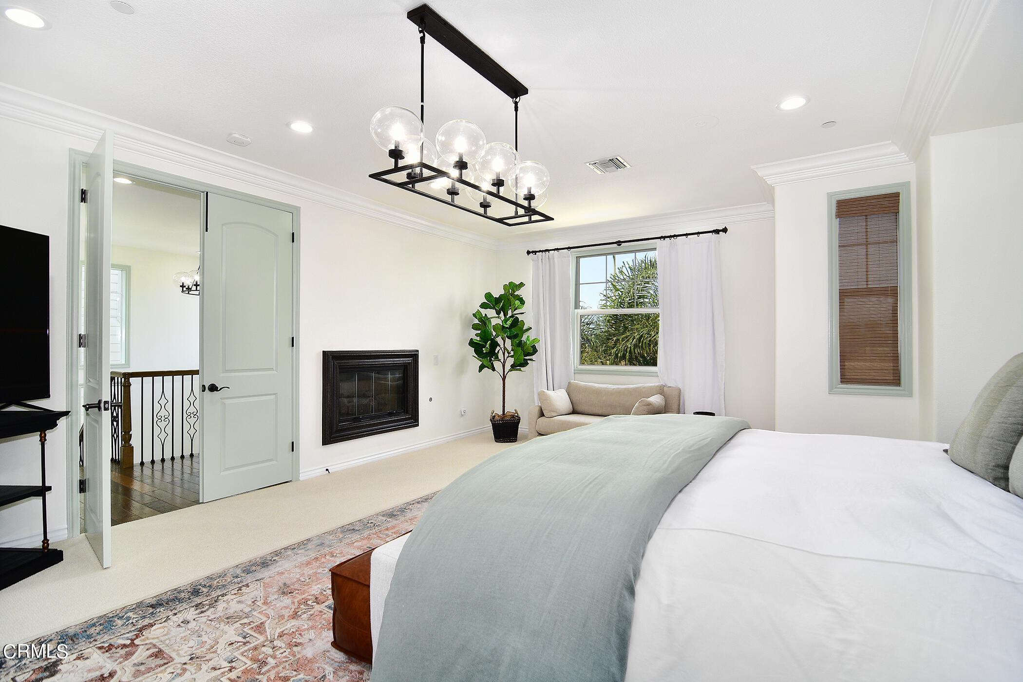 4011 Adriatic Street Oxnard, CA 93035 - Photo 15 of 31 a bedroom with a large bed and a chandelier