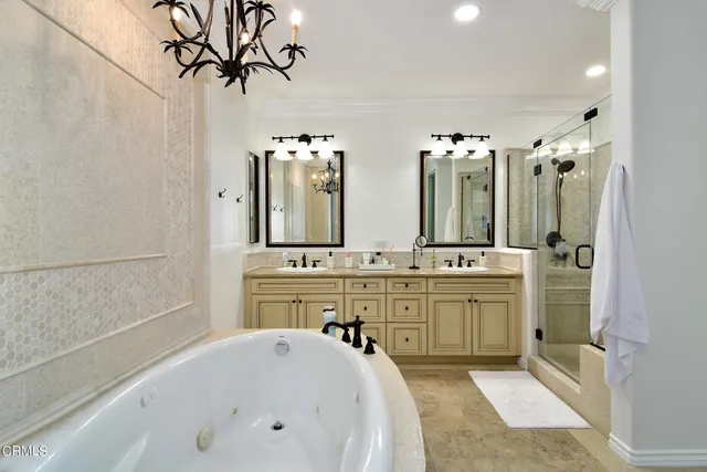 a spacious bathroom with a double vanity sink mirror and bathtub