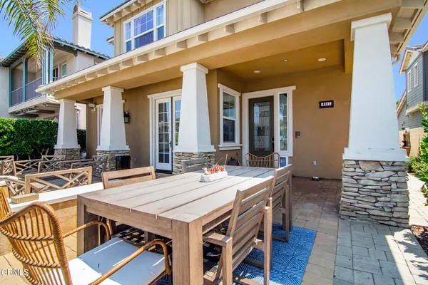 a view of a patio with table and chairs